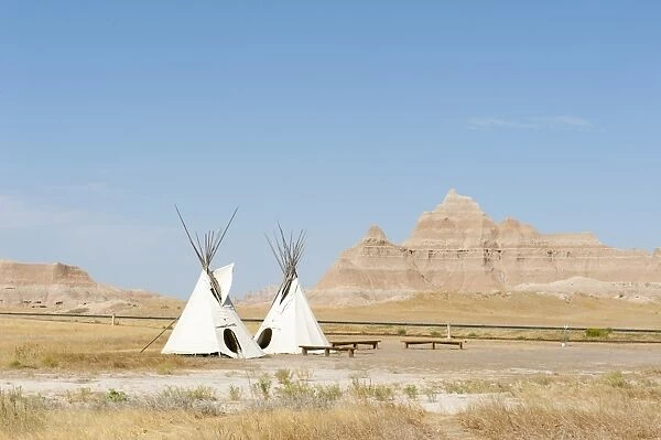 Teepees, tents of the Oglala Lakota or Oglala Sioux subtribes, eroded landscape and grass prairie, Badlands National Park, South Dakota, USA, United States of America, North America