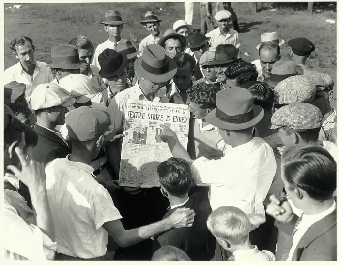 Framed Print : Textile Workers Look at Newspaper Framed Print : Textile Workers Look at Newspaper