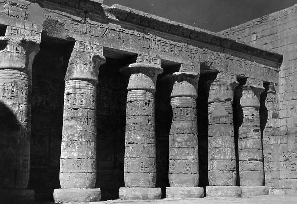 Thebes. circa 1955: Remains of the city of Thebes with a wall showing a colonnade