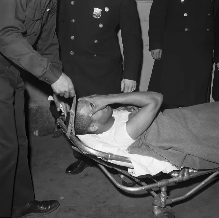 Framed Print : Thomas Hagan on Stretcher Covering Face Framed Print : Thomas Hagan on Stretcher Covering Face