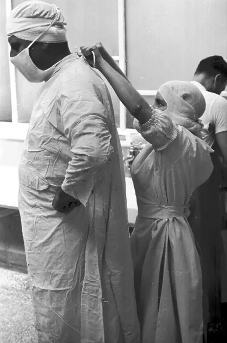 Framed Print : Tie Back. 1st October 1938: A nurse ties a surgeon's gown before an operation Framed Print : Tie Back. 1st October 1938: A nurse ties a surgeon's gown before an operation