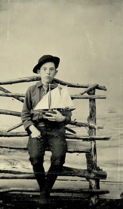 Framed Print : Tintype photograph from 1870s of boy holding a model sailboat Framed Print : Tintype photograph from 1870s of boy holding a model sailboat