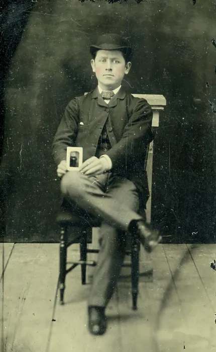 Framed Print : Tinype of young man holding a photograph Framed Print : Tinype of young man holding a photograph