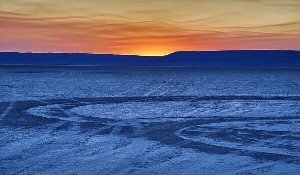 Tire tracks on Alvord Desert at sunrise, Oregon, USA