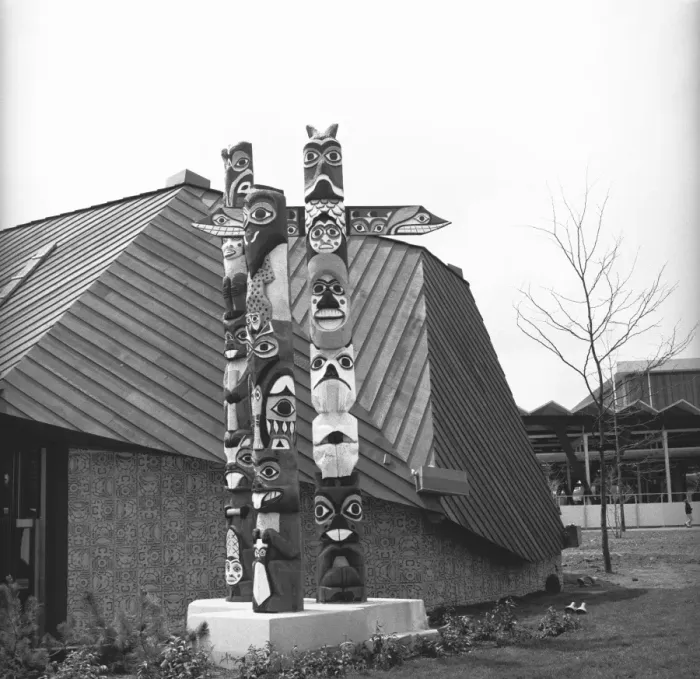 Framed Print : Totem poles at building, (B&W) Framed Print : Totem poles at building, (B&W)