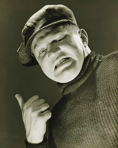 Tough guy showing thumb up, (B&W), close-up, portrait, low angle view