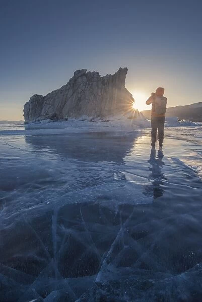 Tourist talking photo at frozen Lake Baikal