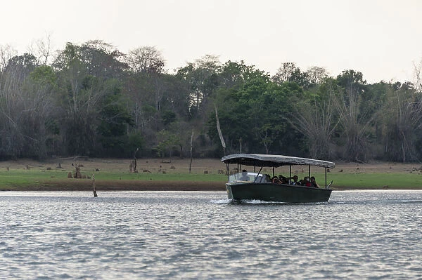 Tourists in safari boat on Kabini Reservoir, Nagarhole National Park, Karnataka, India