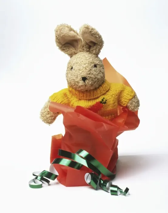 Framed Print : Toy rabbit with wrapping paper and ribbons