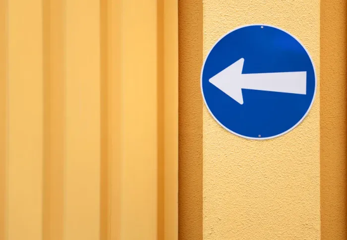 Framed Print : Traffic sign, arrow to the left, on the wall of a building Framed Print : Traffic sign, arrow to the left, on the wall of a building