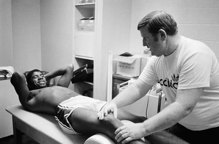 Framed Print : Trainer Working on Magic Johnson's Leg Framed Print : Trainer Working on Magic Johnson's Leg