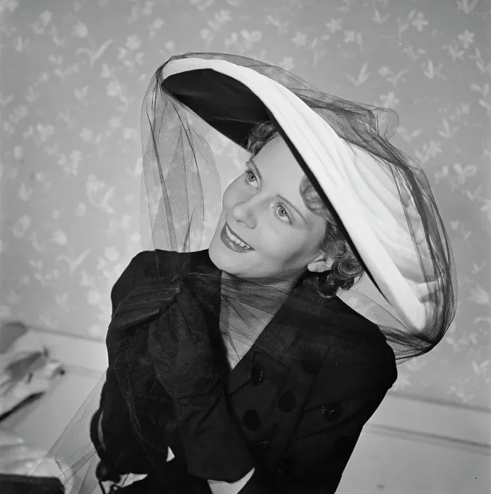 Framed Print : Très Chic. A female model wearing a dark polka-dot v-neck outfit with dark gloves Framed Print : Très Chic. A female model wearing a dark polka-dot v-neck outfit with dark gloves