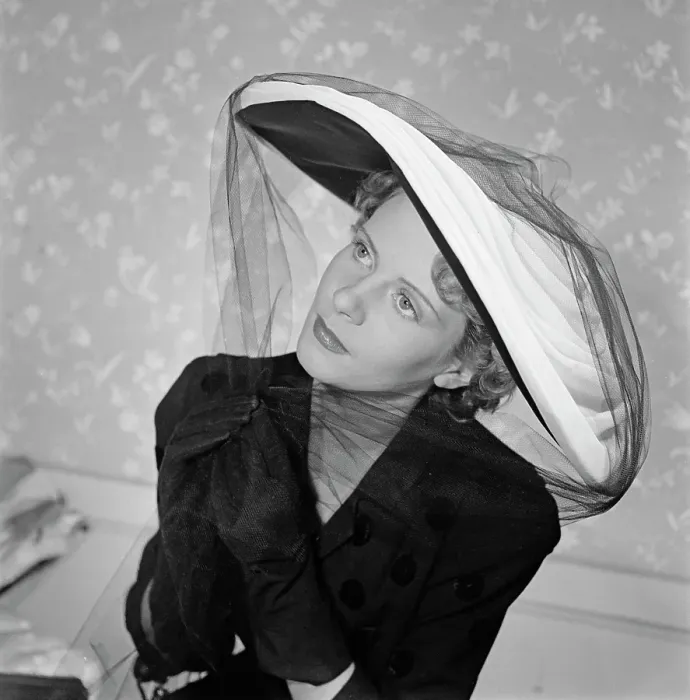 Framed Print : Très Chic. A female model wearing a dark polka-dot v-neck outfit with dark gloves Framed Print : Très Chic. A female model wearing a dark polka-dot v-neck outfit with dark gloves