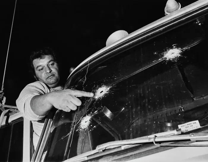 Framed Print : Truck Driver Pointing At Windscreen Bullet Holes Framed Print : Truck Driver Pointing At Windscreen Bullet Holes