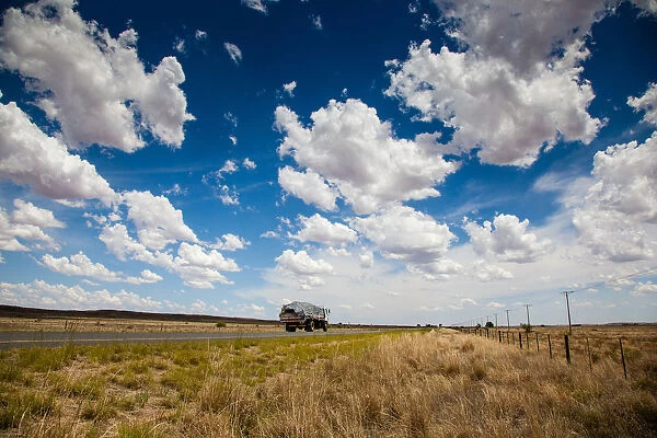 A truck travels along the N12 in the dry and arid landscape in the Northern Cape
