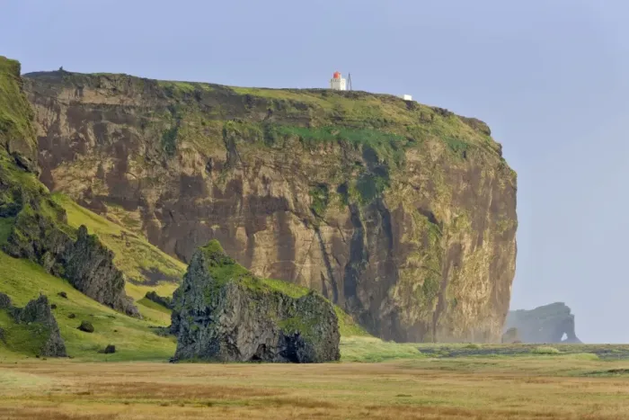 Framed Print : Tuff rock with a lighthouse, Dyrholaey, Vik i Myrdal, Southern Region, Iceland