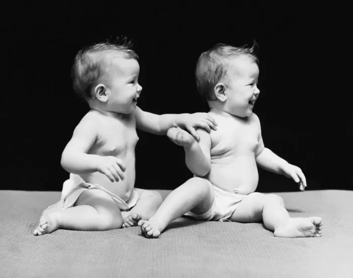 Framed Print : Twin baby girls in diapers, sitting on blanket Framed Print : Twin baby girls in diapers, sitting on blanket