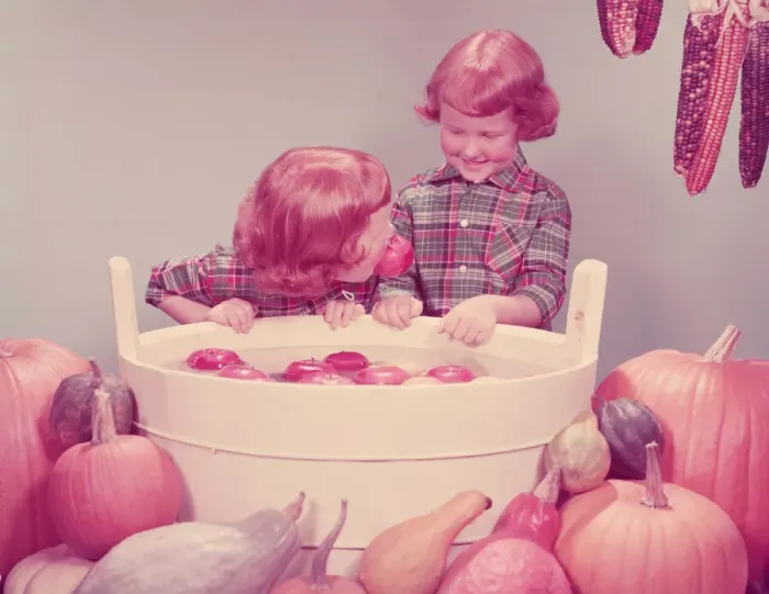 Framed Print : Twin red haired girls bobbing for apples at party. (Photo by H Framed Print : Twin red haired girls bobbing for apples at party. (Photo by H