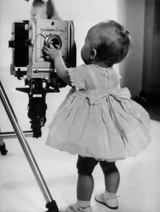 Framed Print : Two-Year-Old Girl Inspects Camera Lens Framed Print : Two-Year-Old Girl Inspects Camera Lens