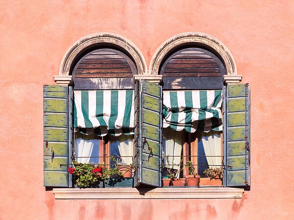 Typical ornate windows of a colorful house in Murano, Venice