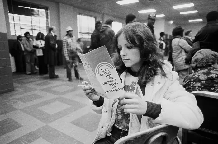 Framed Print : Unemployed Woman Reads A Brochure Framed Print : Unemployed Woman Reads A Brochure