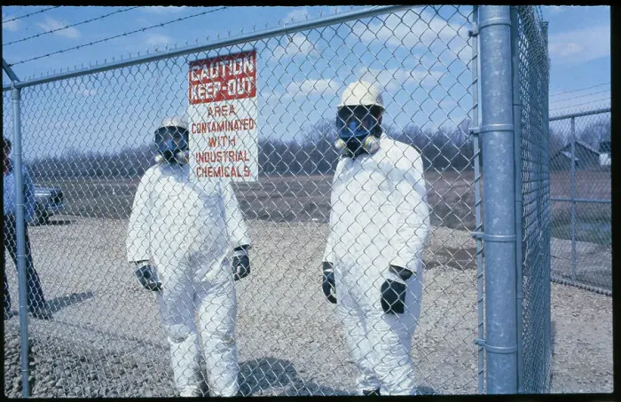Framed Print : Uniformed Toxic Dump Workers Pausing Behind Fence Framed Print : Uniformed Toxic Dump Workers Pausing Behind Fence