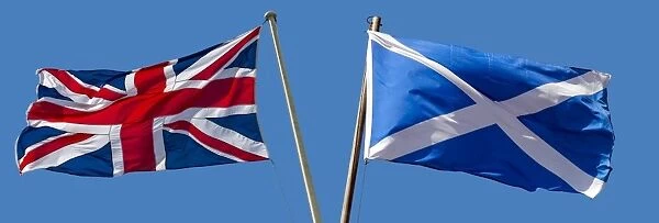 The Union Flag and the Scottish flag, Saltire, blowing in opposite directions