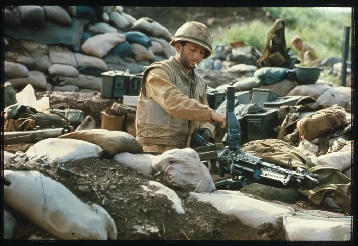 Framed Print : U.S. Marine Looking at Machine Gun