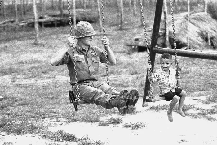 Framed Print : U.S. Soldier and Vietnamese Child on Swingset Framed Print : U.S. Soldier and Vietnamese Child on Swingset