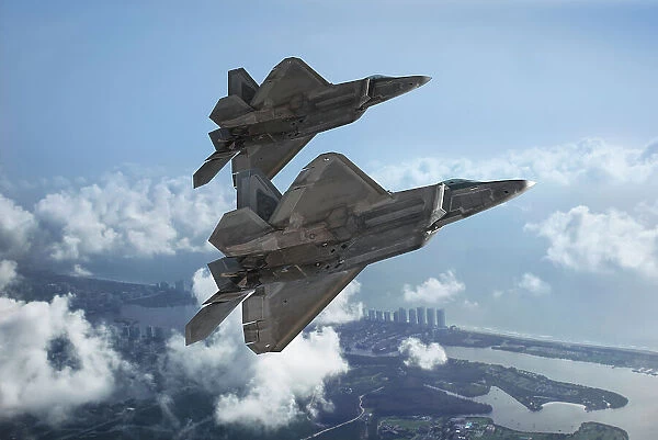 Two USAF Lockheed Martin F-22A Raptor stealth fighters flying over the coastline of Florida