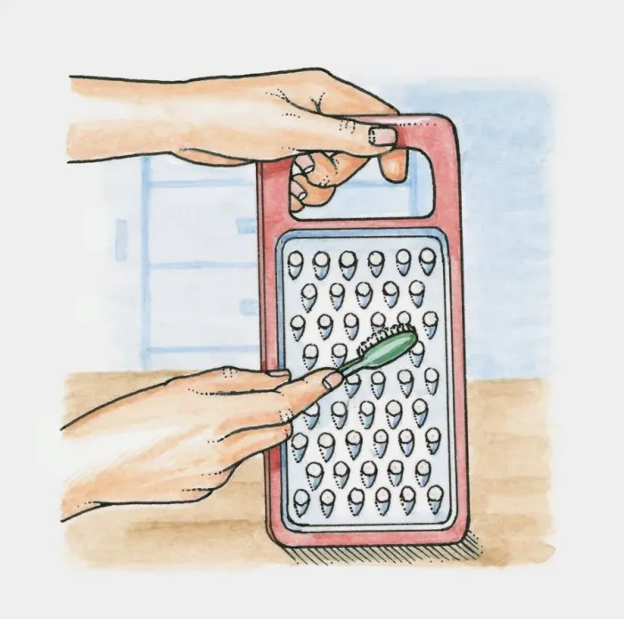 Framed Print : Using a toothbrush to clean a grater Framed Print : Using a toothbrush to clean a grater