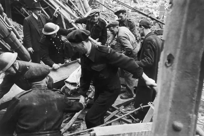 Framed Print : V2 Victim. An air raid casualty is stretchered away by rescue workers in Framed Print : V2 Victim. An air raid casualty is stretchered away by rescue workers in