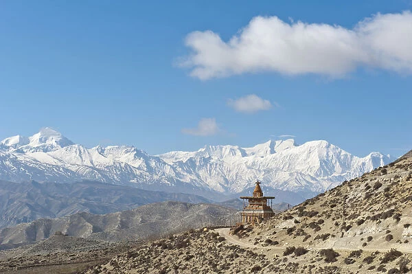 Vast landscape with stupa, the snow-covered mountains of the Annapurna Range at back, near Geling, Upper Mustang, Lo, Nepal