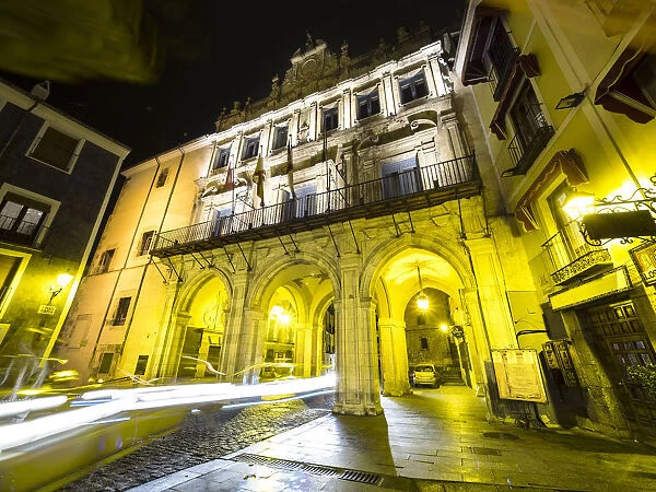 Vehicles circulating in the night in front of the Town hall. Cuenca is a UNESCO World Heritage site, local government