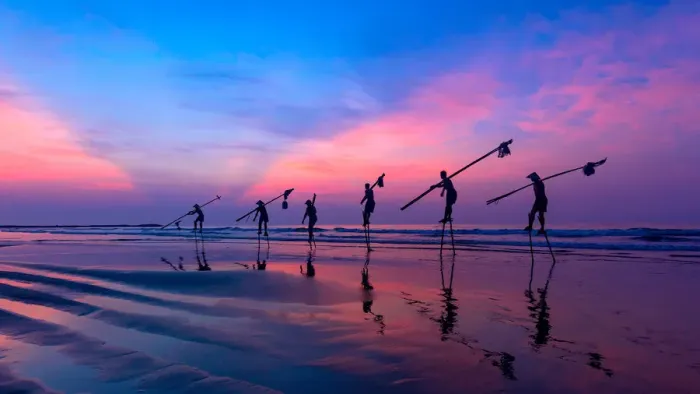 Framed Print : Vietnam - Fishermen going with stilts, hanging fishing tools on the beach, in sunrise Framed Print : Vietnam - Fishermen going with stilts, hanging fishing tools on the beach, in sunrise