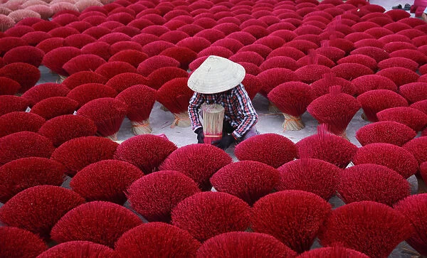 Vietnam - woman making red insense