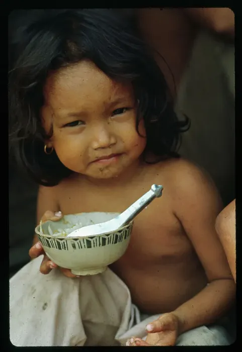Framed Print : Vietnamese Girl Eating Bowl of Rice Framed Print : Vietnamese Girl Eating Bowl of Rice