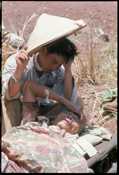 Framed Print : Vietnamese Refugee Shielding Elderly Woman from Sun Framed Print : Vietnamese Refugee Shielding Elderly Woman from Sun
