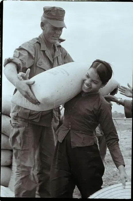 Framed Print : Vietnamese Woman Helps US Marine Framed Print : Vietnamese Woman Helps US Marine