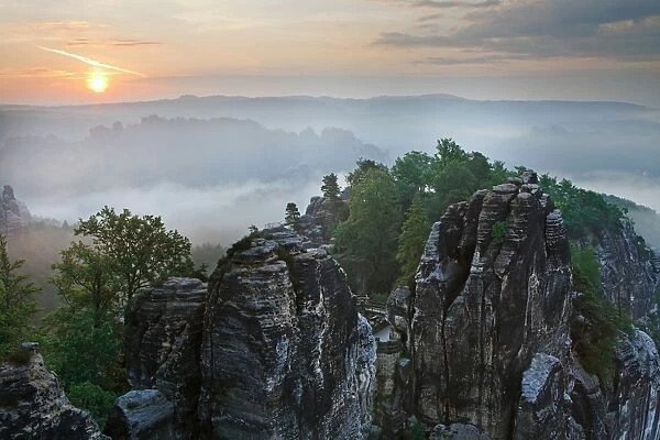 View from the Bastei rock formation, sunrise, fog, Saxon Switzerland National Park, Saxon Switzerland region, Saxony, Germany