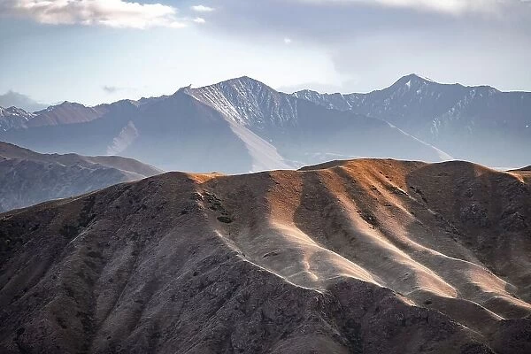 View over eroded mountainous landscape with brown hills, mountains and steppe, Chuy province, Kyrgyzstan