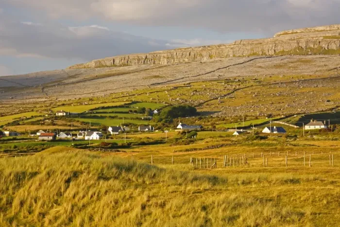 Framed Print : View Of Fanore Village And Limestone Mountain In The Background In The Burren Region Framed Print : View Of Fanore Village And Limestone Mountain In The Background In The Burren Region