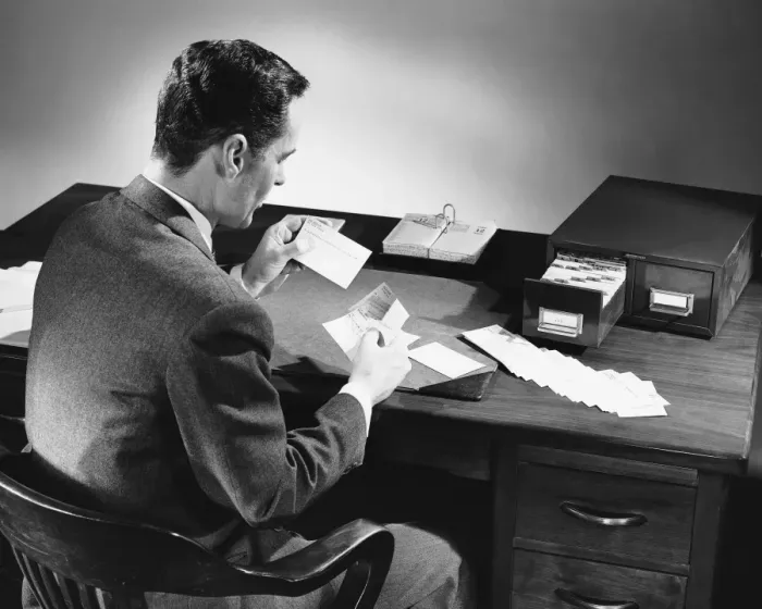 Framed Print : Back view of man sitting and looking at address cards Framed Print : Back view of man sitting and looking at address cards