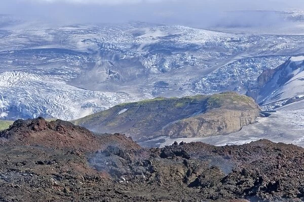 View across new lava fields created by a volcanic eruption in 2010 to the Myrdalsjokull glacier, at the long-distance hiking trail from Skogar via Fimmvorouhals to the Thorsmork mountain ridge, Porsmork, Iceland
