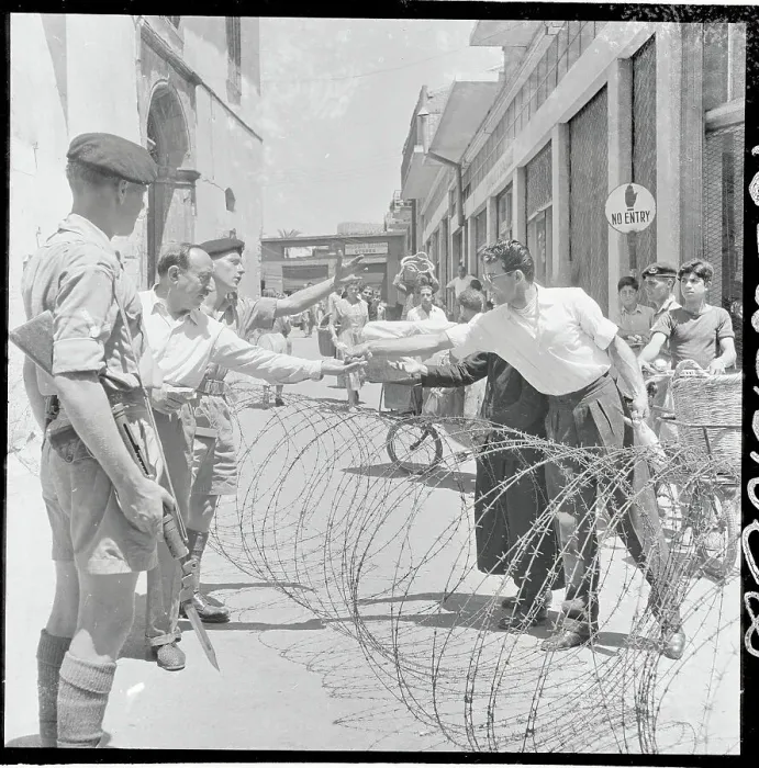 Framed Print : View of Soldiers Near Barbed Wire Barricade Framed Print : View of Soldiers Near Barbed Wire Barricade