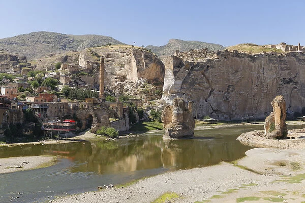 View of the town with the minaret of the El Rizk Mosque, pillars of the bridge built by the Ortocides, Hasankeyf, Tigris River, Batman Province, Southeastern Anatolia Region, Anatolia, Turkey