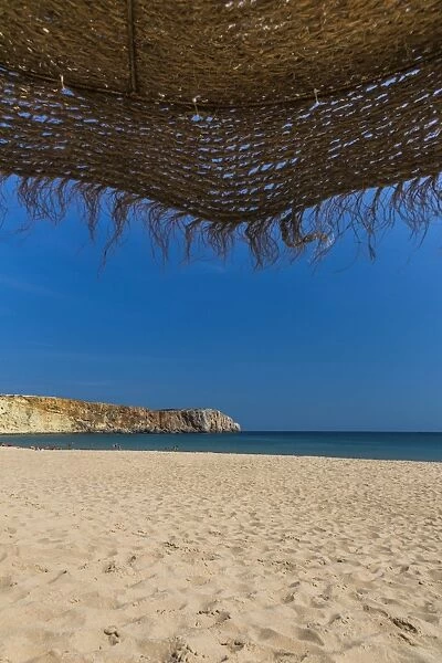 View from underneath a parasol out onto the beach, Praia da Mareta, Sagres, Algarve, Portugal, Europe