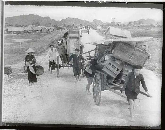 Framed Print : Villagers Pushing Carts in Flight Framed Print : Villagers Pushing Carts in Flight