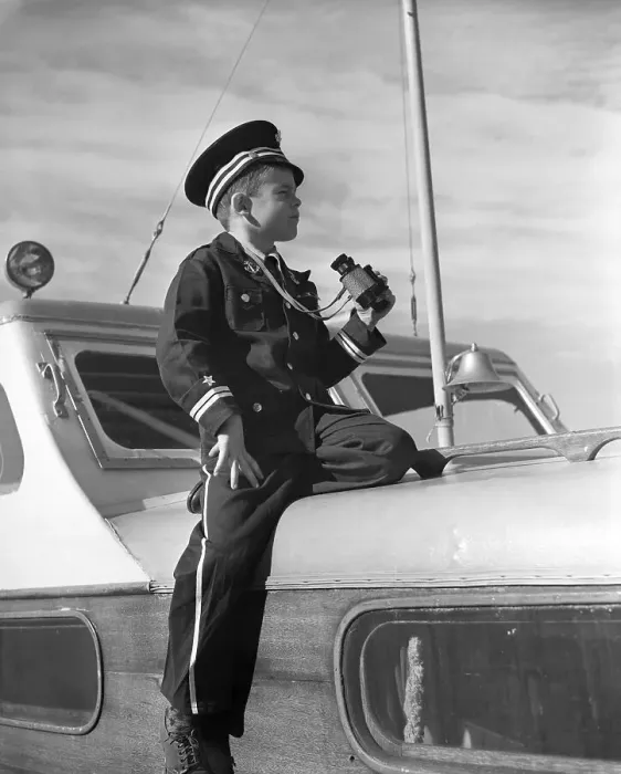 Framed Print : Vintage photograph showing boy (8-9) in naval uniform sitting on yacht deck Framed Print : Vintage photograph showing boy (8-9) in naval uniform sitting on yacht deck