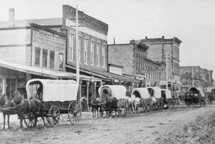 Framed Print : Wagon Train Moving Through Town Framed Print : Wagon Train Moving Through Town